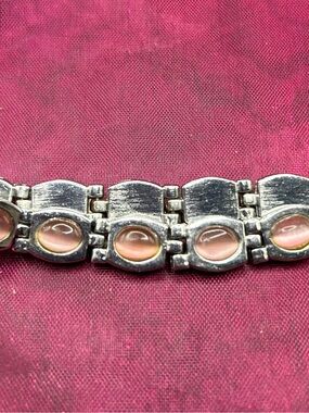 97- pink cat eye silver tone bracelet